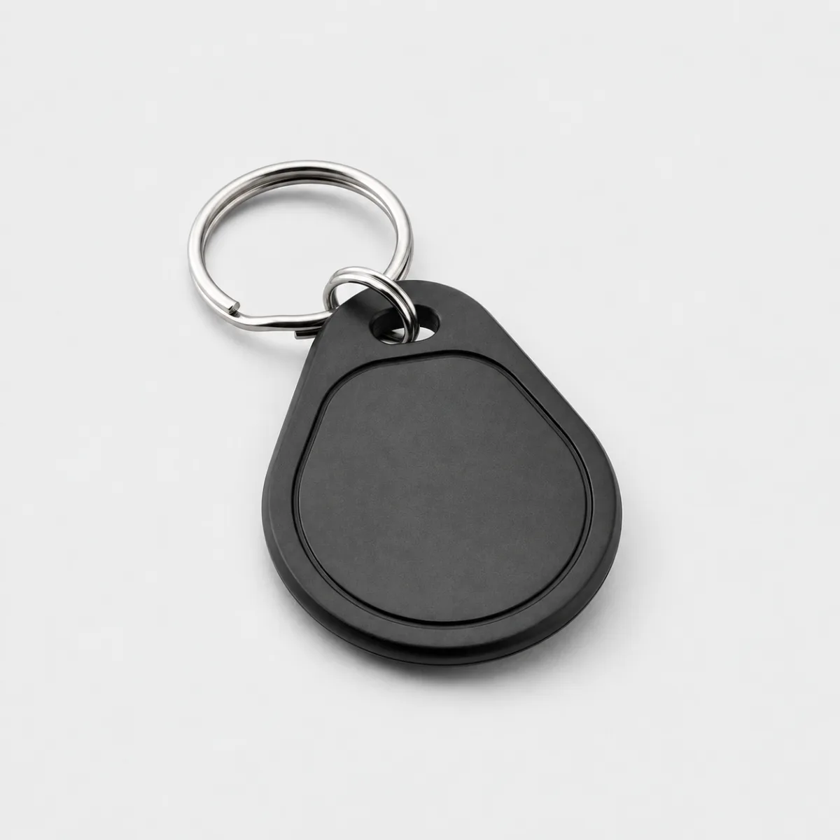 A plain black teardrop tap key tag on a split ring